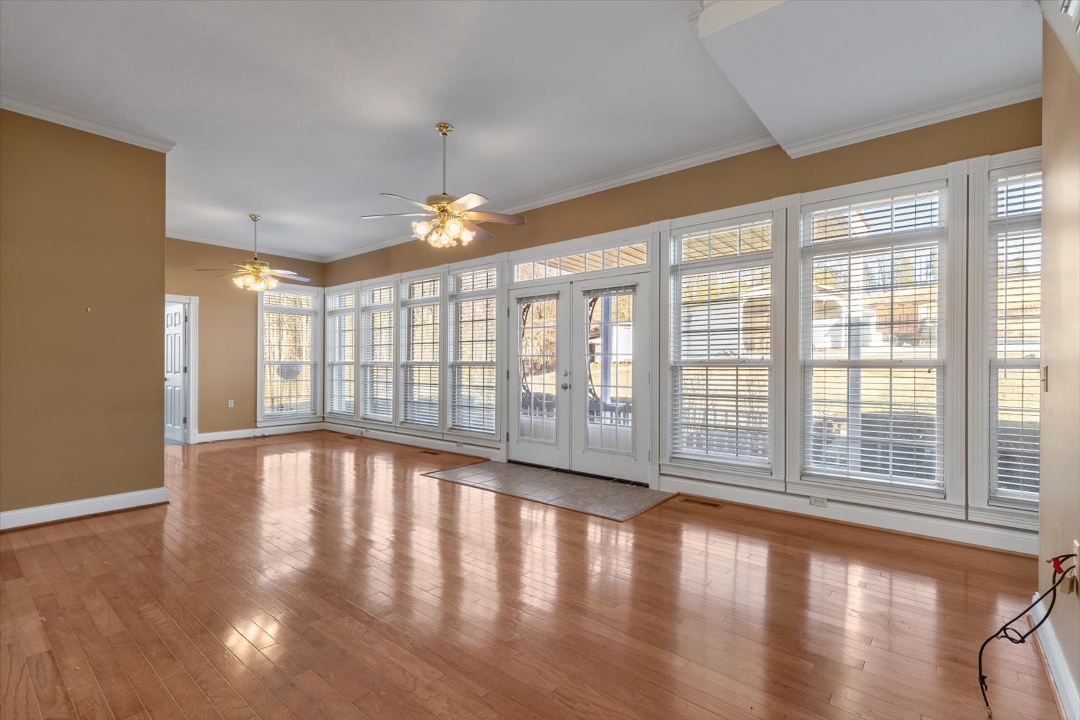 3160 Tom Holt Road Clifton, TN 38425 - Photo 18 of 53 a view of an empty room with wooden floor and a window