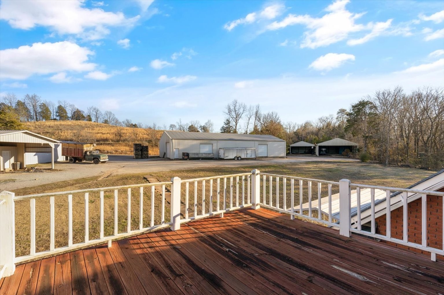 3160 Tom Holt Road Clifton, TN 38425 - Photo 23 of 53 a view of a balcony with wooden floor and fence