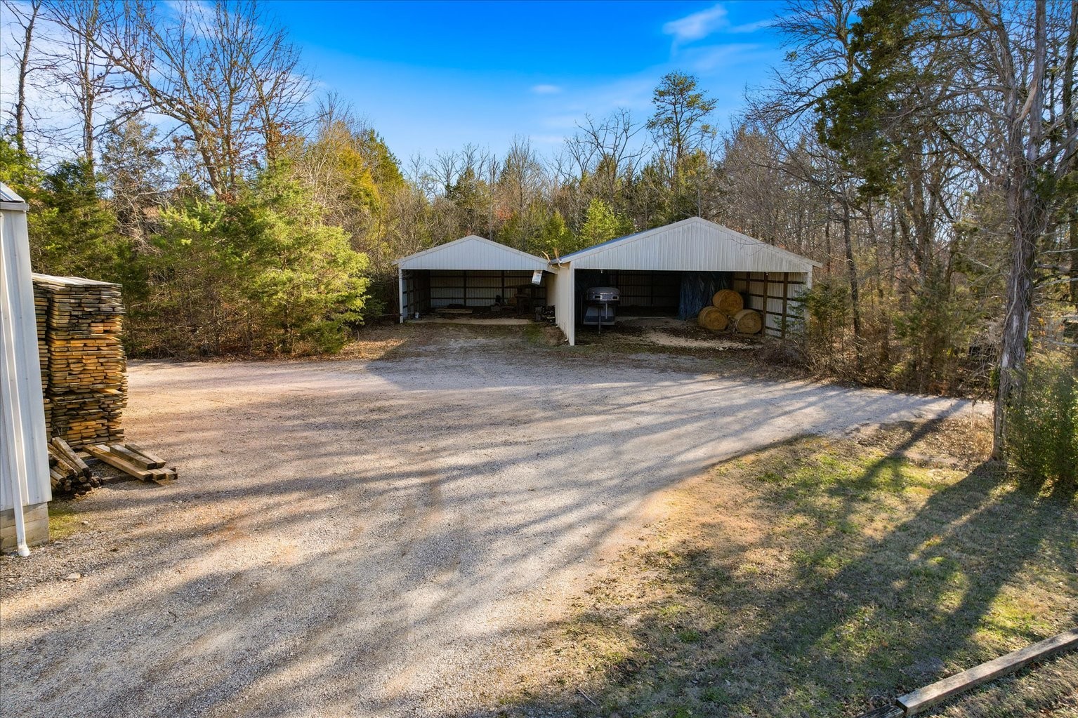 3160 Tom Holt Road Clifton, TN 38425 - Photo 48 of 53 a backyard of a house with table and chairs under an umbrella