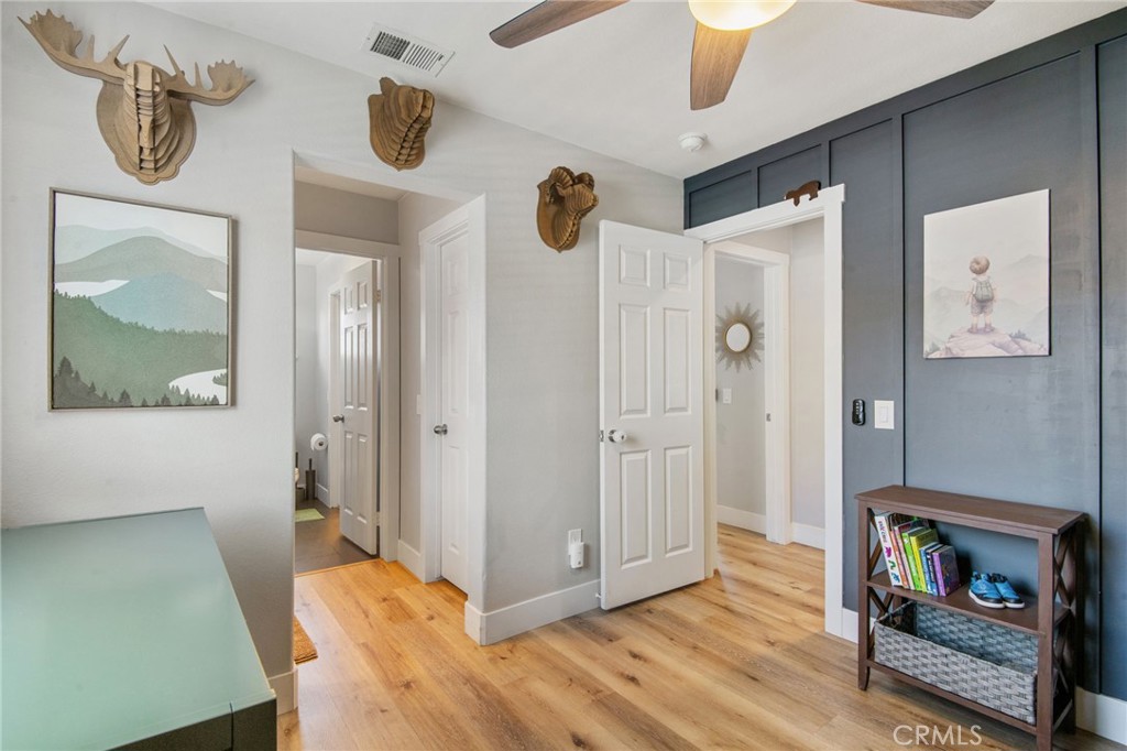 40456 Windsor Road Temecula, CA 92591 - Photo 22 of 38 a view of hallway with wooden floor and cabinet