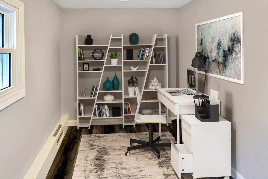 11 Groton School Road, Unit 4 Ayer, MA 01432 - Photo 6 of 11 a view of a workspace with furniture and a book shelf