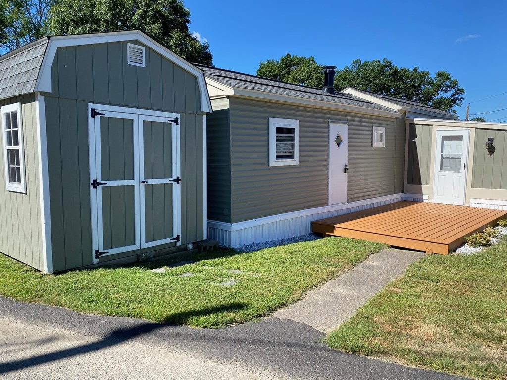 11 Groton School Road, Unit 4 Ayer, MA 01432 - Photo 10 of 11 a front view of a house with a yard
