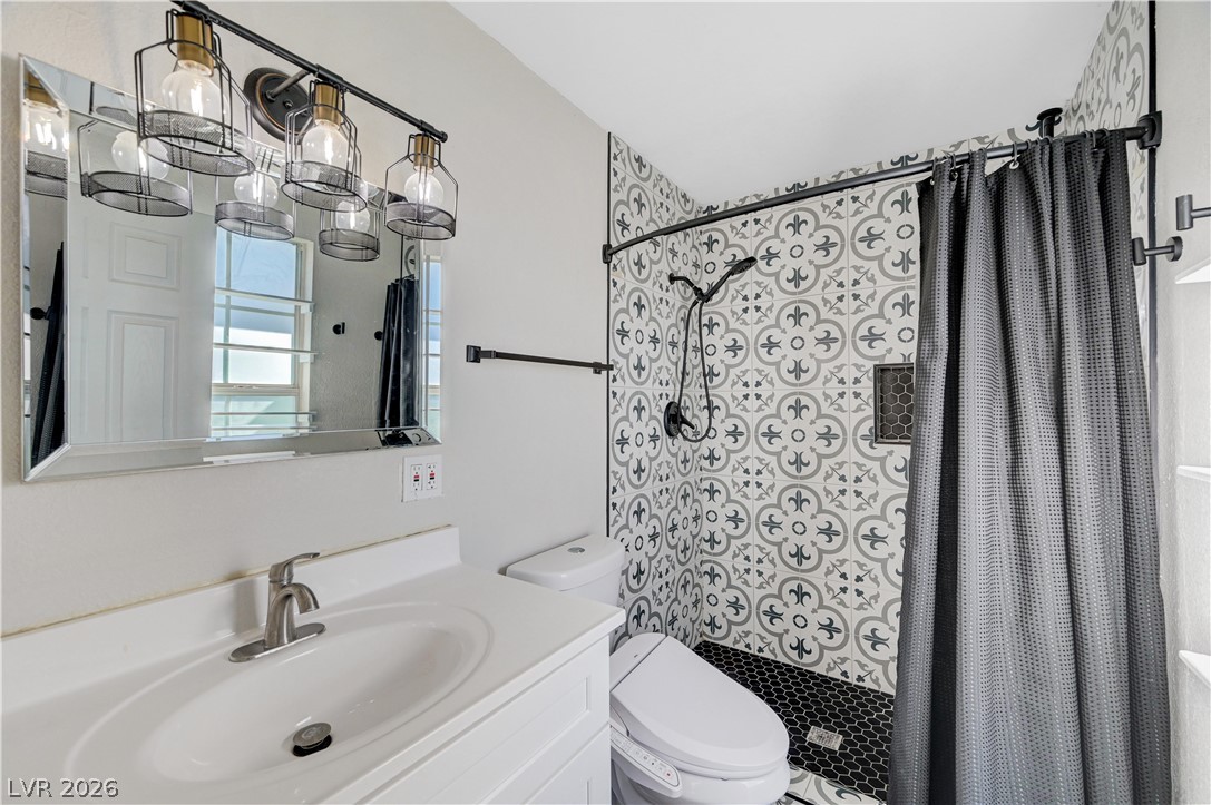 1331 Pinto Road Boulder City, NV 89005 - Photo 4 of 46 A well-appointed bathroom features a stylish vanity and a shower area with attractive patterned tilework.