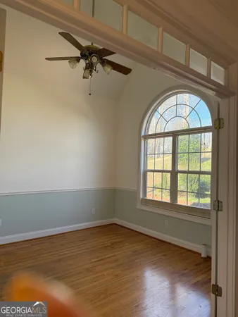 a view of room with wooden floor