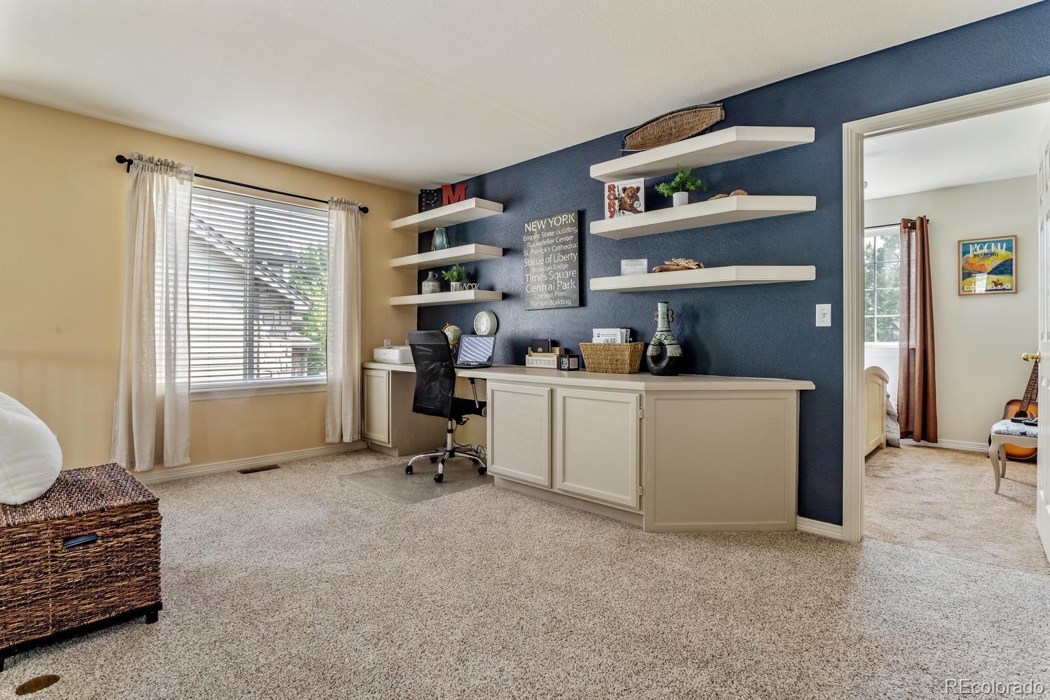 6966 South Riviera Street Aurora, CO 80016 - Photo 14 of 30 a room with furniture and a window
