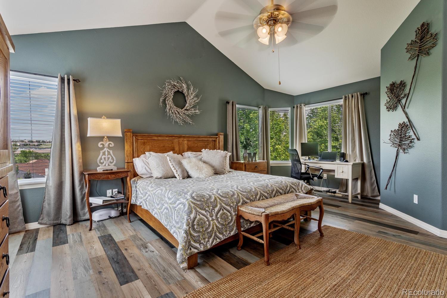 6966 South Riviera Street Aurora, CO 80016 - Photo 16 of 30 a bedroom with a bed and a table