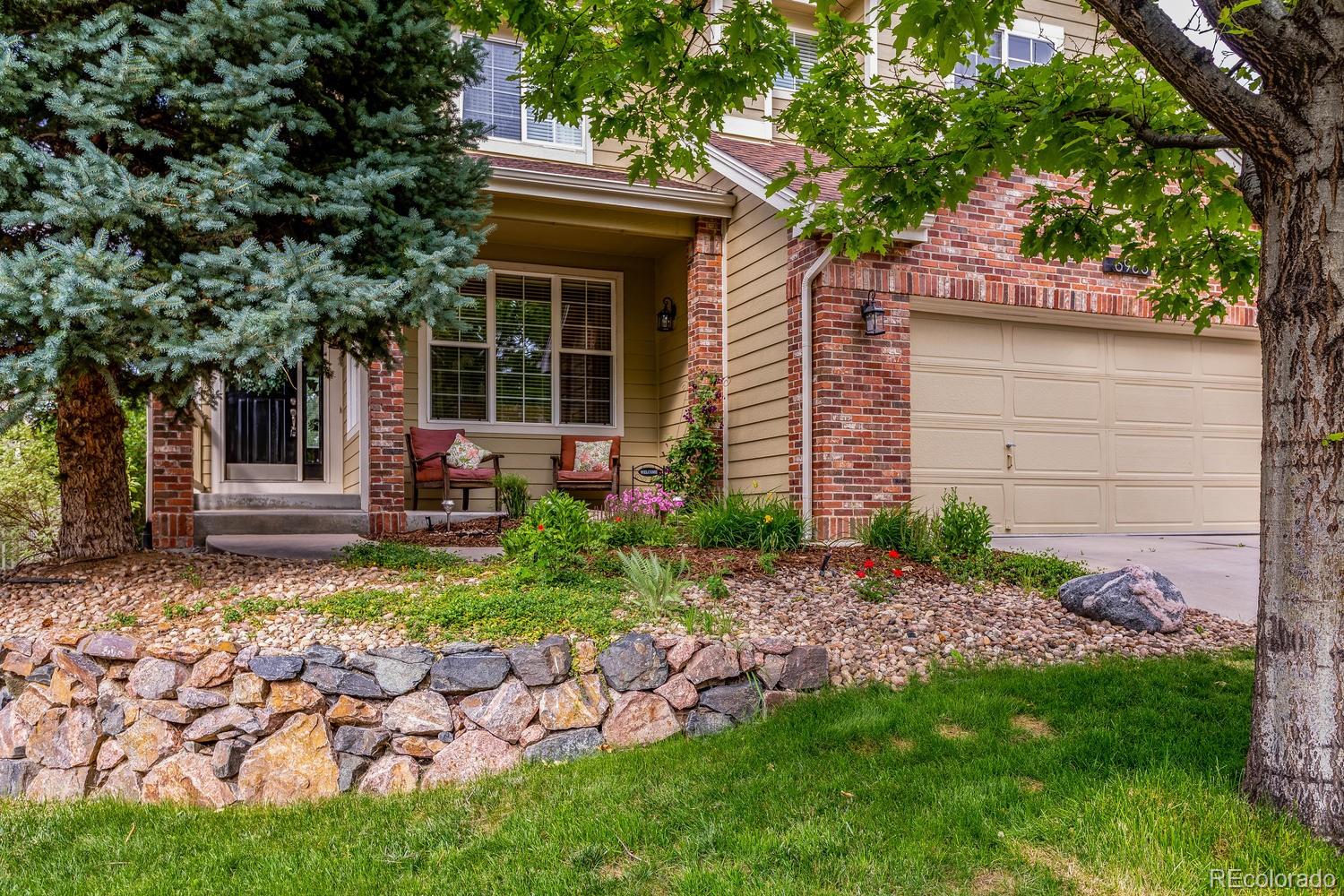 6966 South Riviera Street Aurora, CO 80016 - Photo 2 of 30 a view of a house with a yard and plants