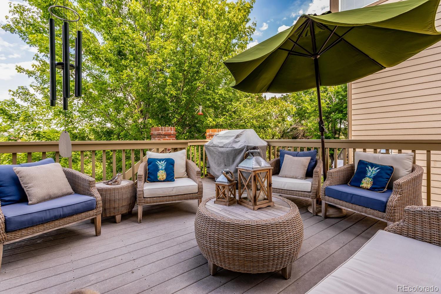 6966 South Riviera Street Aurora, CO 80016 - Photo 26 of 30 an outdoor sitting area with furniture and umbrella