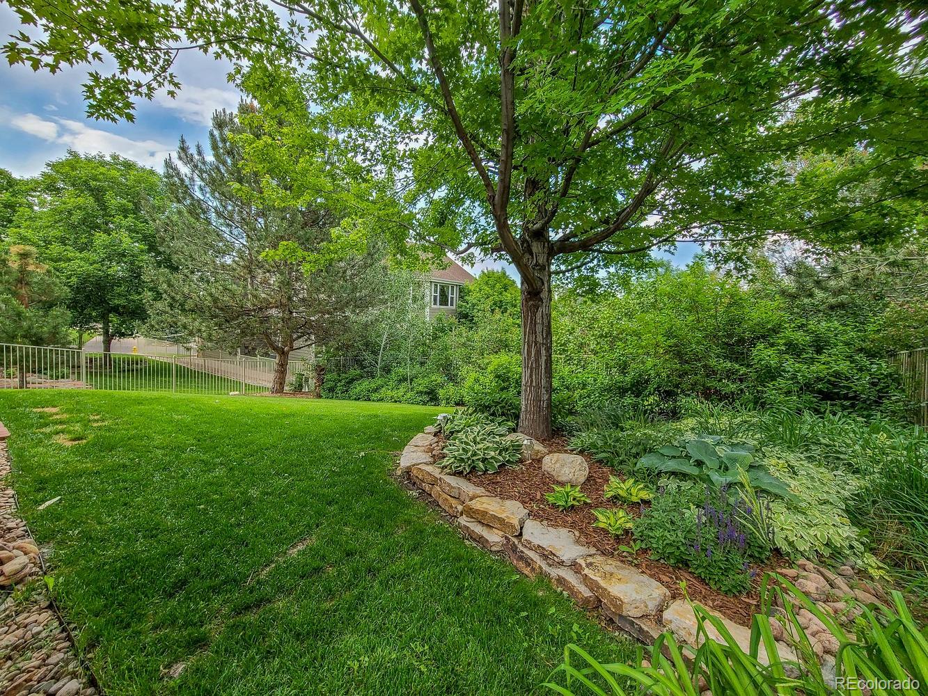 6966 South Riviera Street Aurora, CO 80016 - Photo 29 of 30 a view of a garden with a tree