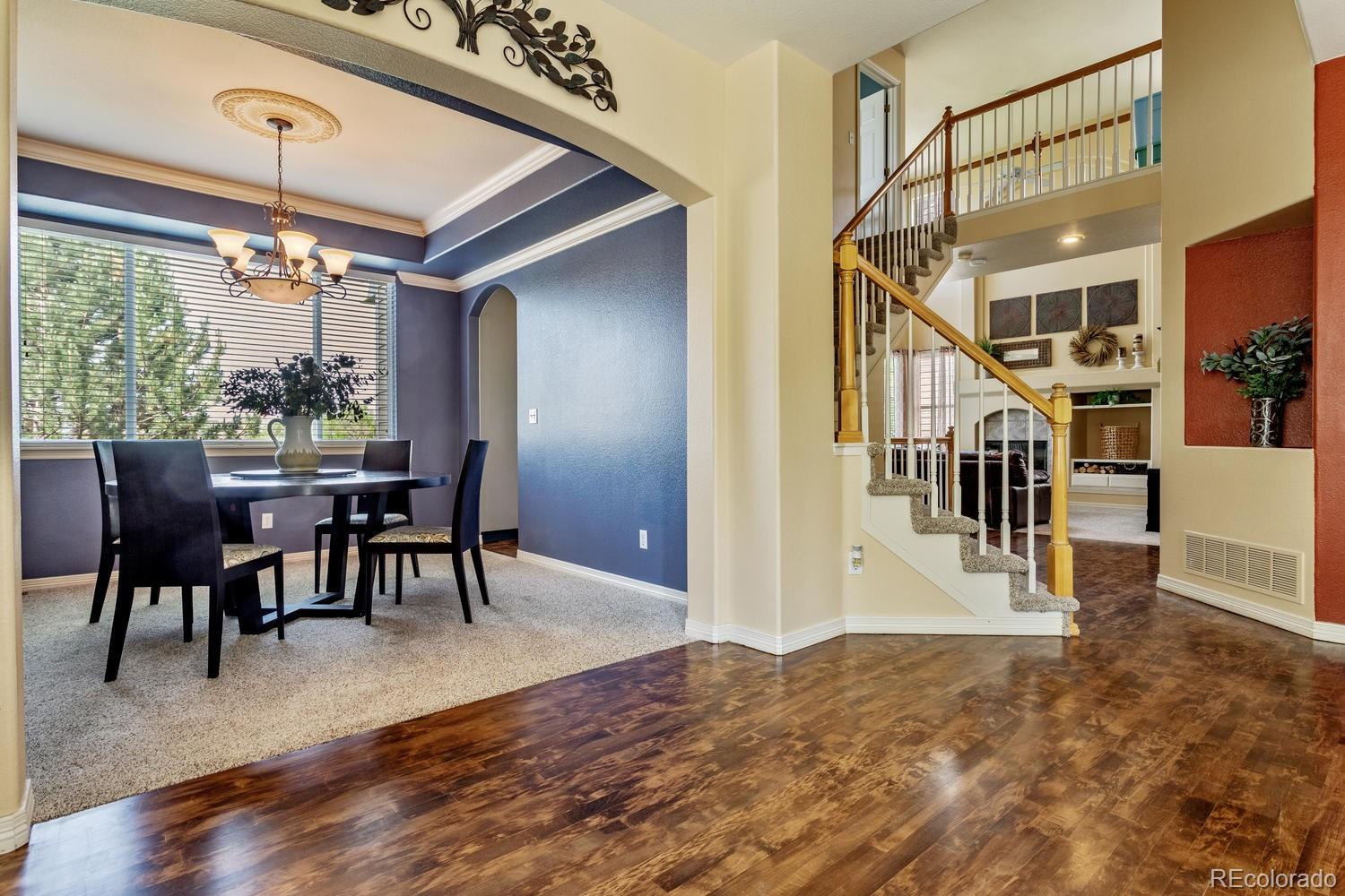 6966 South Riviera Street Aurora, CO 80016 - Photo 3 of 30 a view of a livingroom with furniture wooden floor and windows