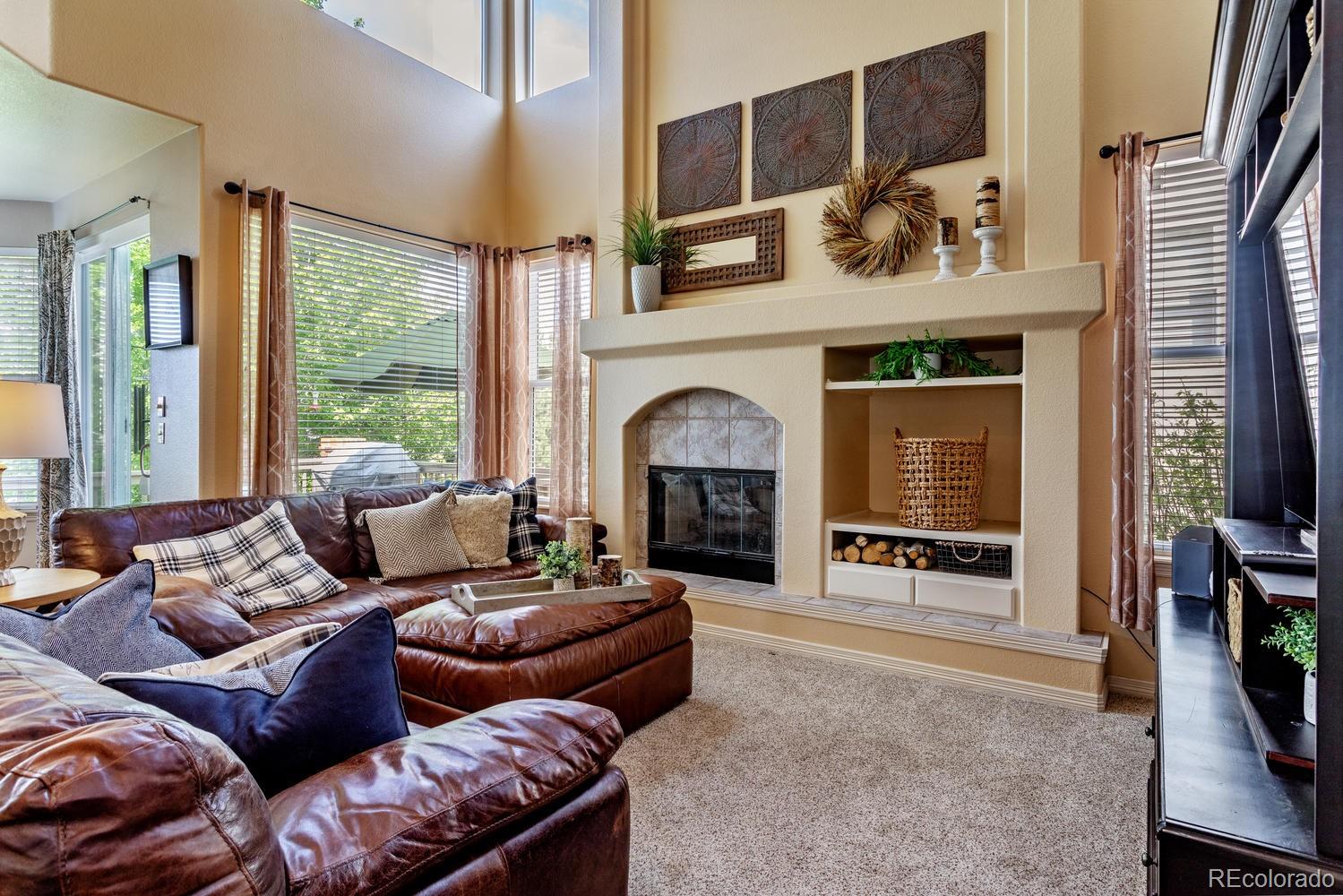 6966 South Riviera Street Aurora, CO 80016 - Photo 7 of 30 a living room with furniture and a fireplace
