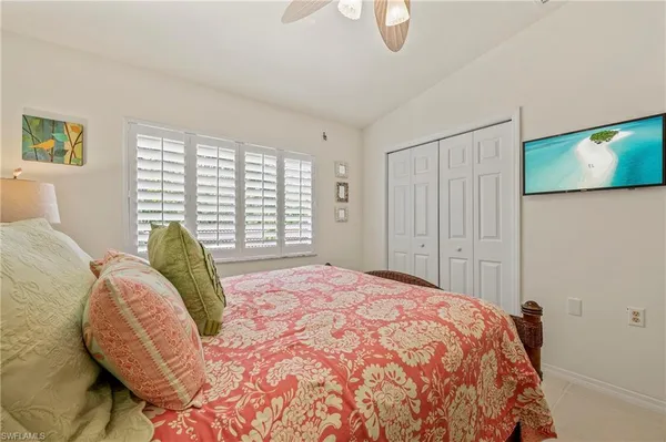 a bed sitting in a bedroom next to a window