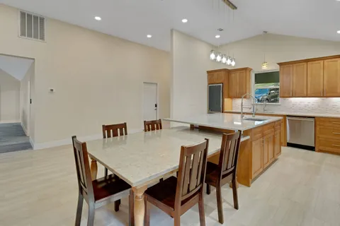 a kitchen with a sink cabinets and wooden floor
