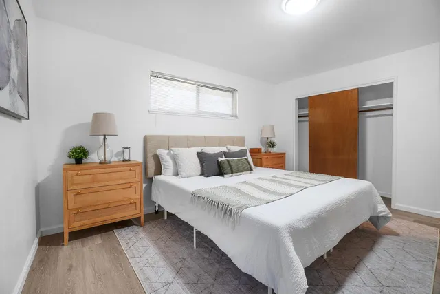 a bedroom with a bed and a painting