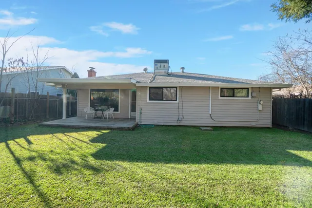a view of a house with backyard porch and sitting area