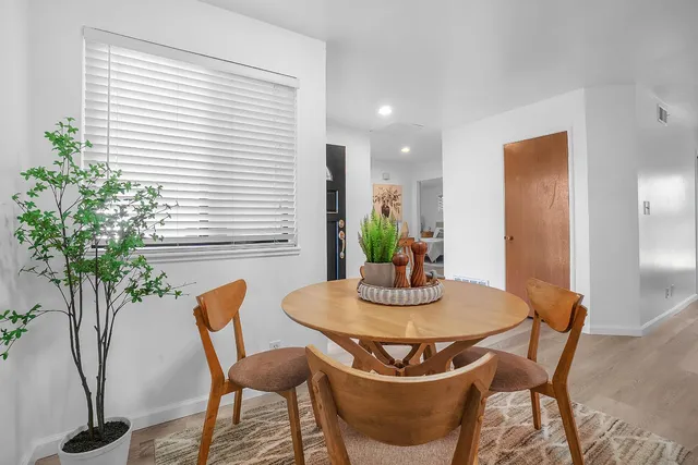 a view of a dining room with furniture and wooden floor
