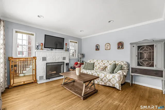 a living room with furniture fireplace and flat screen tv