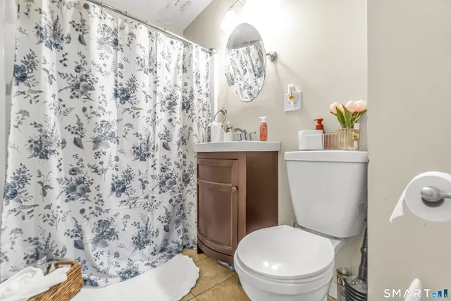 a white toilet sitting next to a bathroom sink