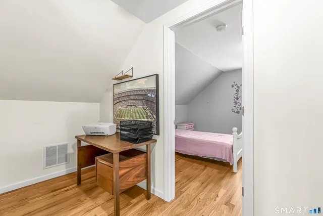 a bedroom with a bed and a table in it