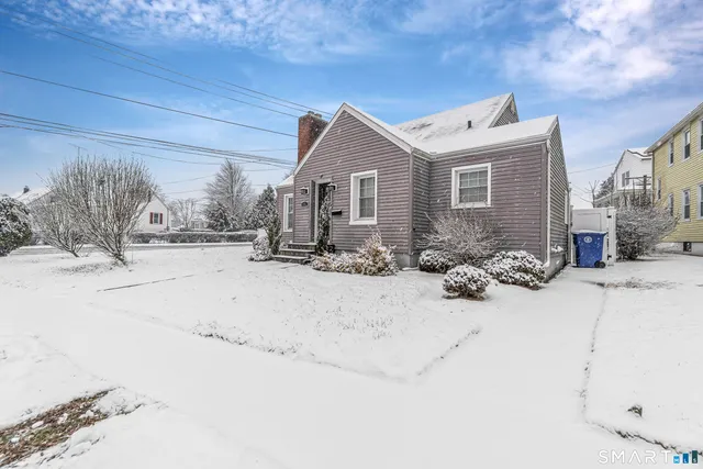 a view of a house with snow on the road