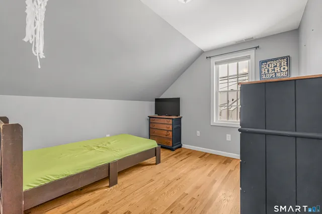 a bedroom with a bed and a television