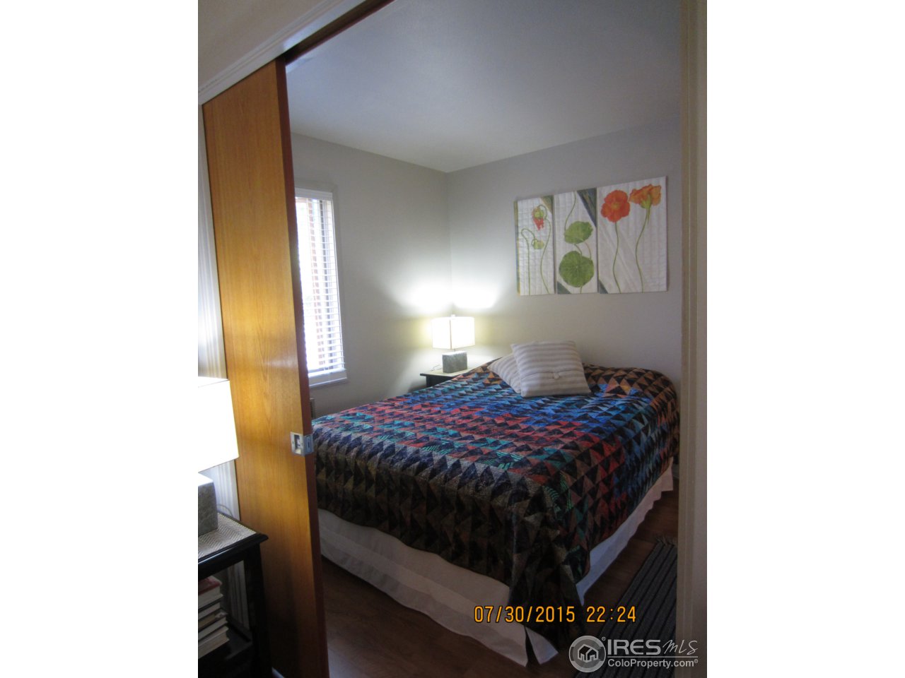 2711 Mapleton Avenue, Unit 1 Boulder, CO 80304 - Photo 8 of 9 a bedroom with a bed and lamp next to a window