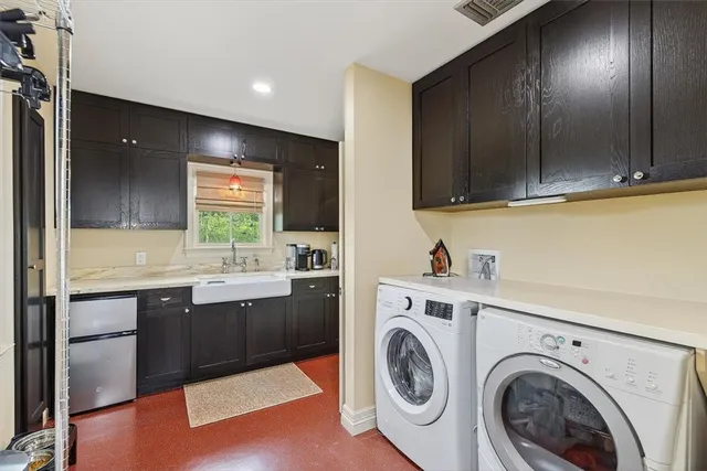 a view of cabinets and washer in a room
