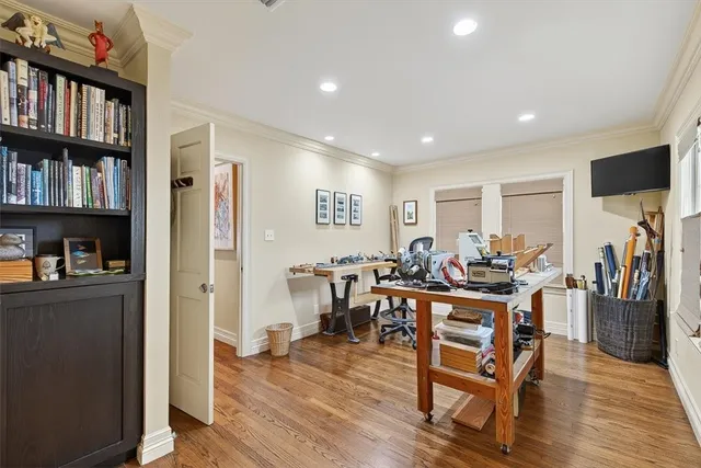 a view of a dining room with furniture and a book shelf