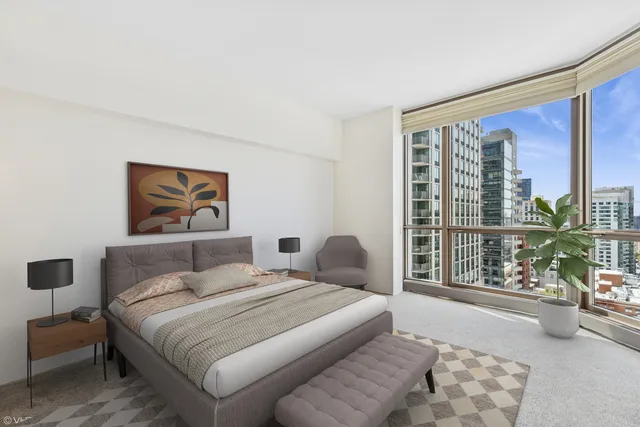 a bedroom with a large bed and a large window