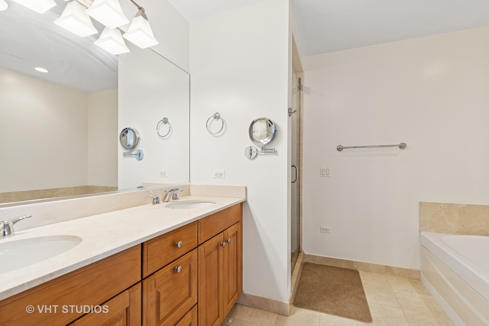 21 East Huron Street, Unit 1806 Chicago, IL 60611 - Photo 15 of 54 a bathroom with a sink a mirror and a bathtub
