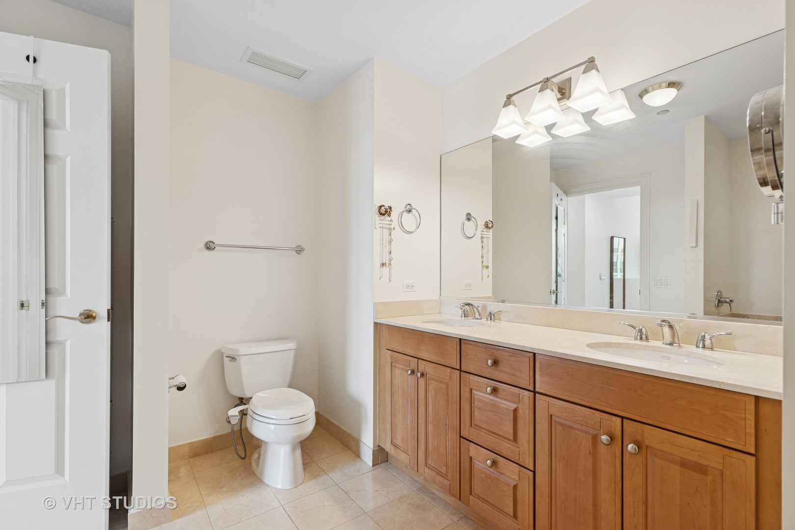 21 East Huron Street, Unit 1806 Chicago, IL 60611 - Photo 16 of 54 a spacious bathroom with a toilet sink and mirror