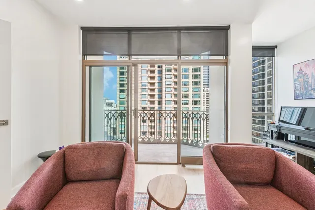 a living room with furniture and a floor to ceiling window