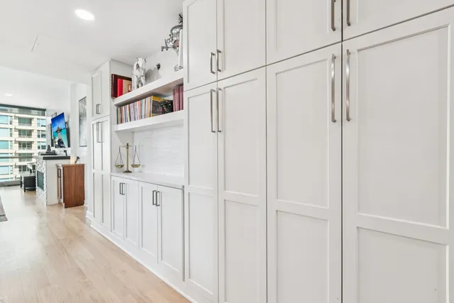 a kitchen with white cabinets and white appliances