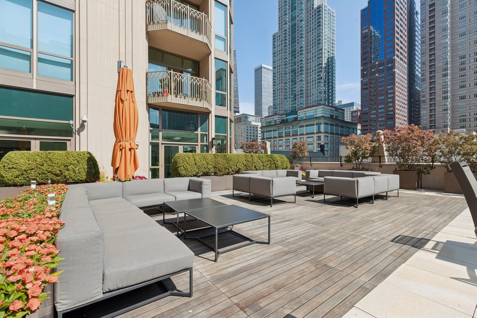 21 East Huron Street, Unit 1806 Chicago, IL 60611 - Photo 42 of 54 a view of a patio with couches table and chairs and potted plants