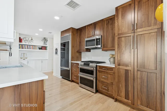 a kitchen with stainless steel appliances granite countertop a refrigerator and a sink