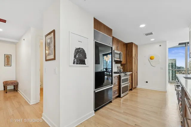 a kitchen with stainless steel appliances kitchen island granite countertop a refrigerator and a stove