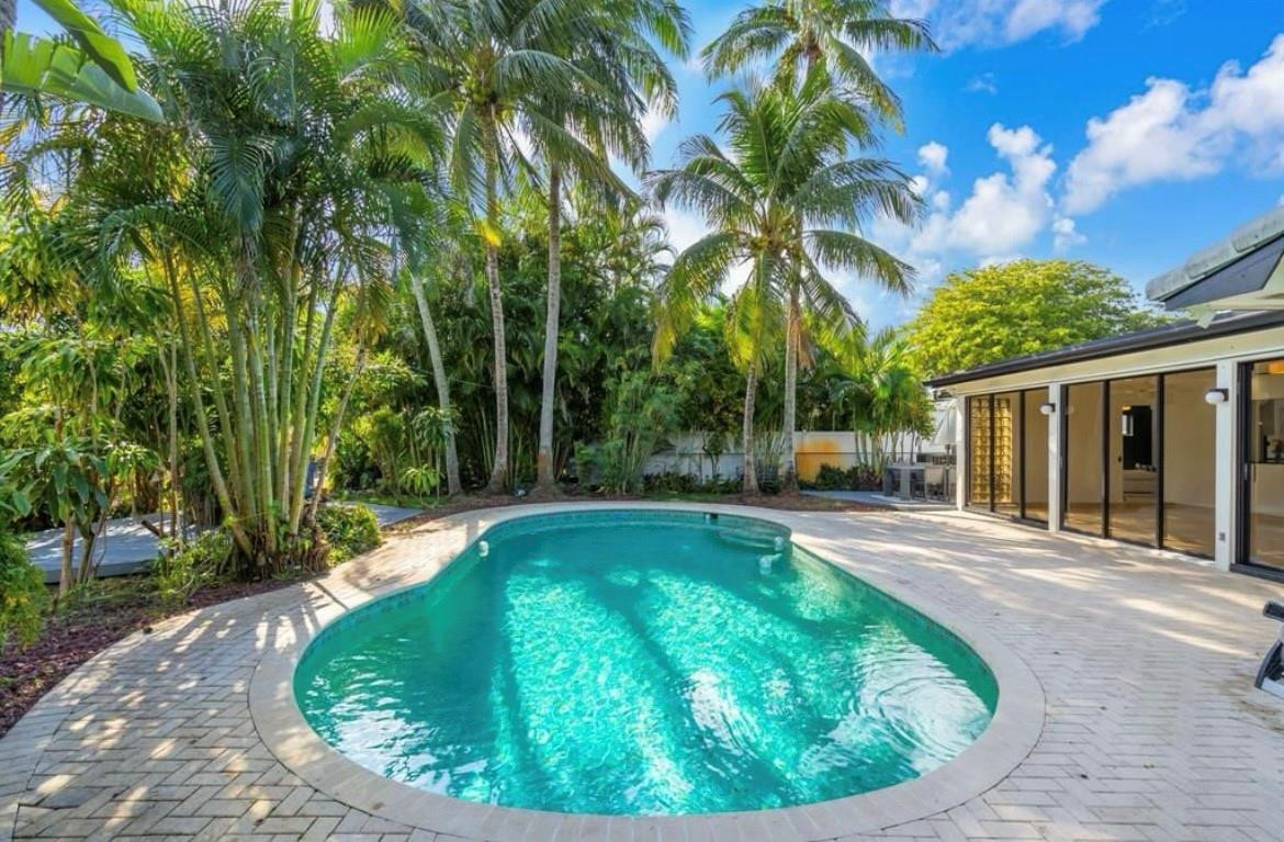 a view of a swimming pool with a patio