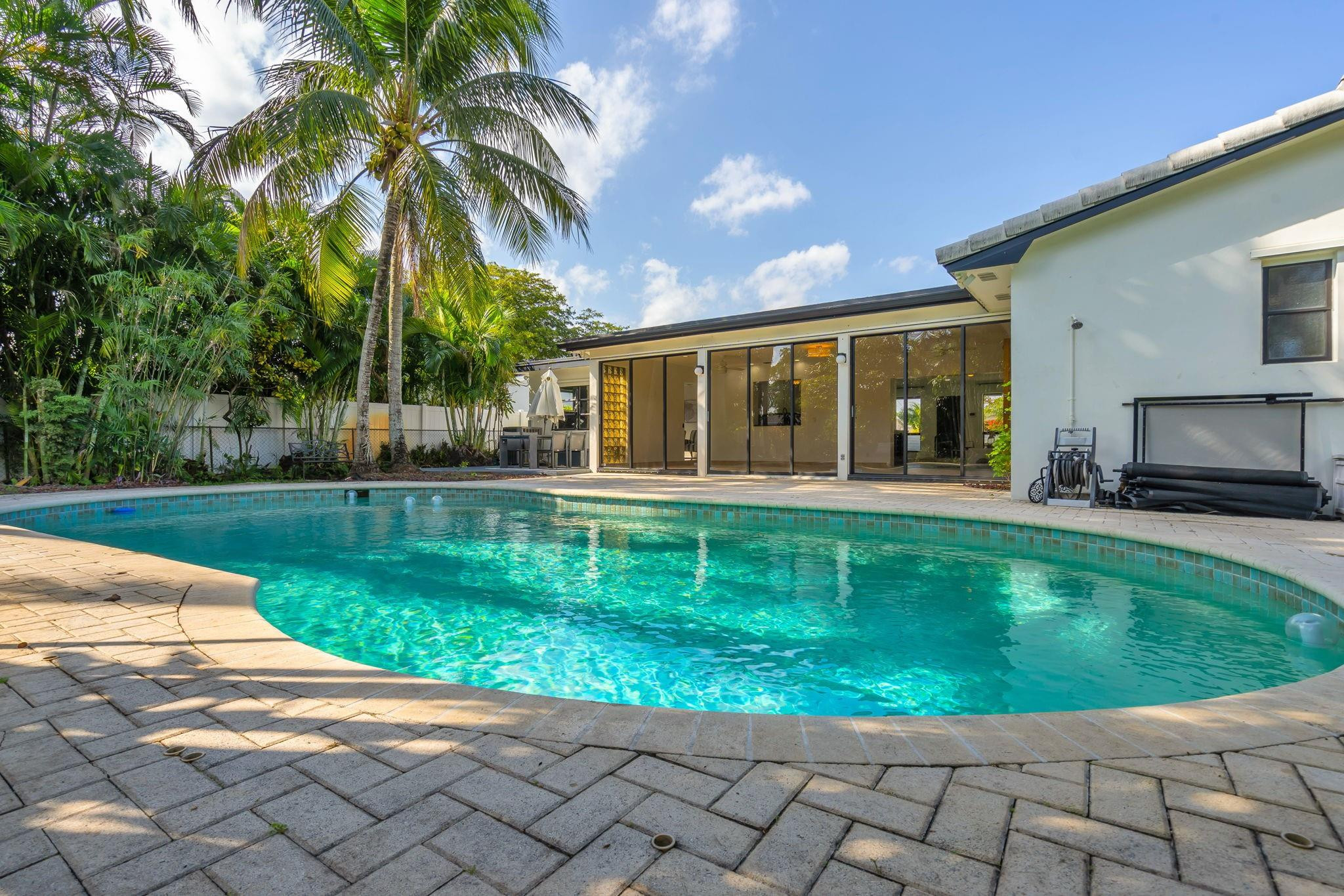 4408 Monroe Street Hollywood, FL 33021 - Photo 19 of 26 a view of a house with a backyard porch and sitting area