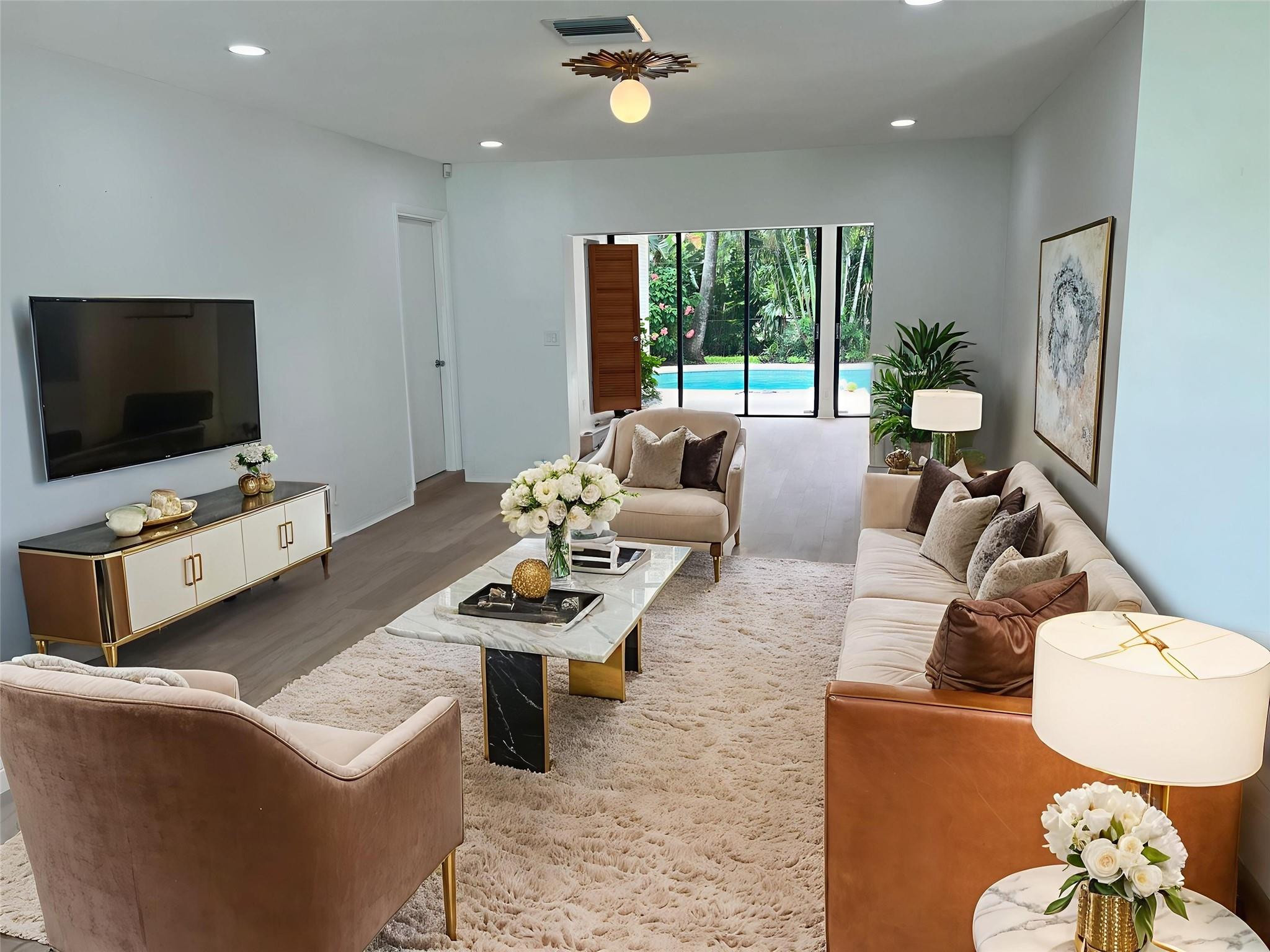 4408 Monroe Street Hollywood, FL 33021 - Photo 5 of 26 a living room with furniture and a flat screen tv