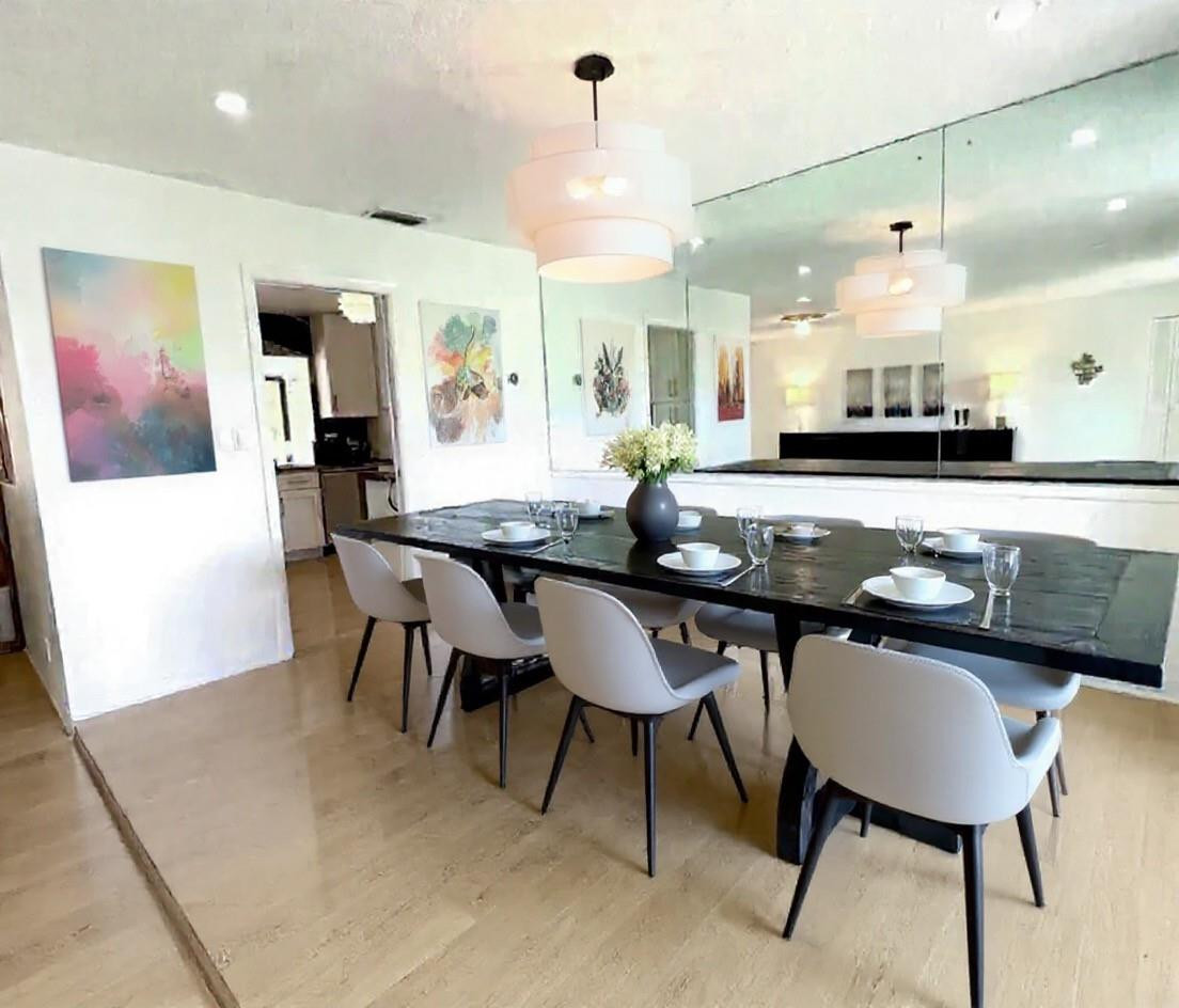 4408 Monroe Street Hollywood, FL 33021 - Photo 6 of 26 a kitchen with a table chairs sink and cabinets