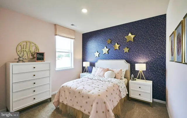 a bedroom with a bed and a dresser