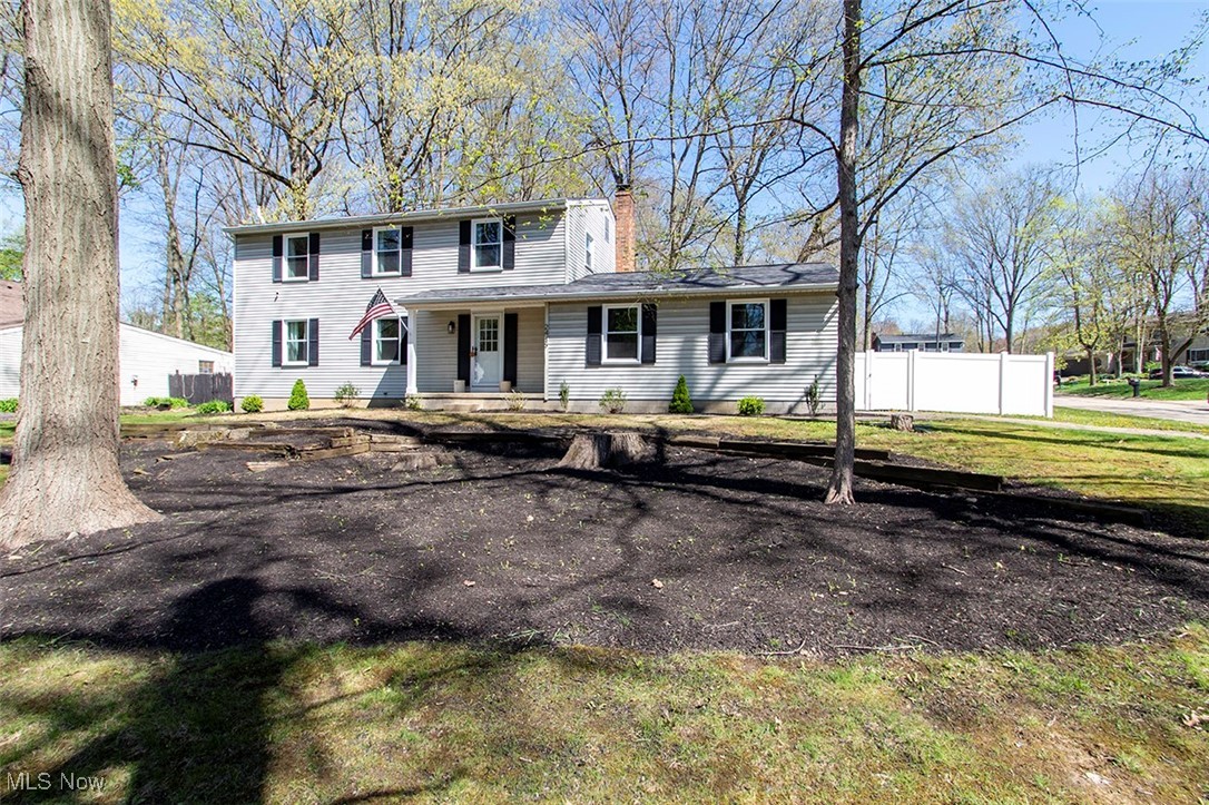 2449 Audubon Road Akron, OH 44320 - Photo 2 of 33 View of front facade featuring a chimney, covered porch, fence, central AC, and a front lawn