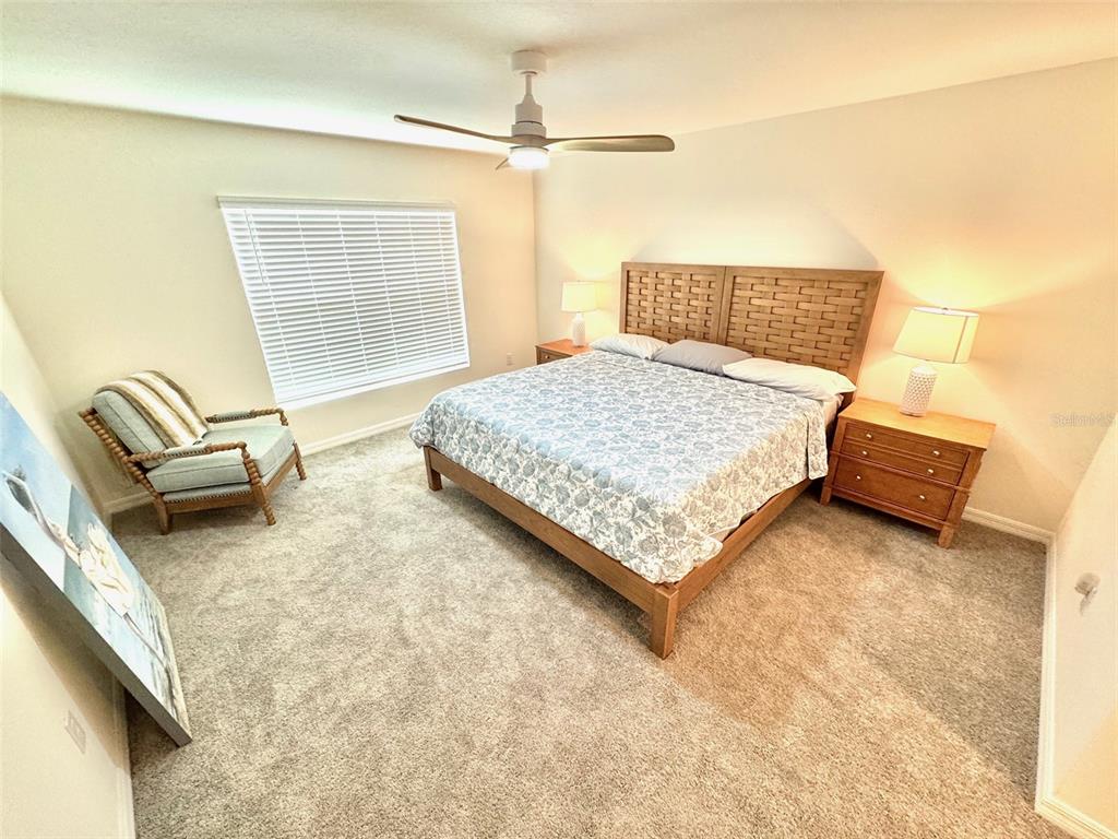 13374 Mylion Way Spring Hill, FL 34610 - Photo 14 of 39 a bedroom with a bed couch and window