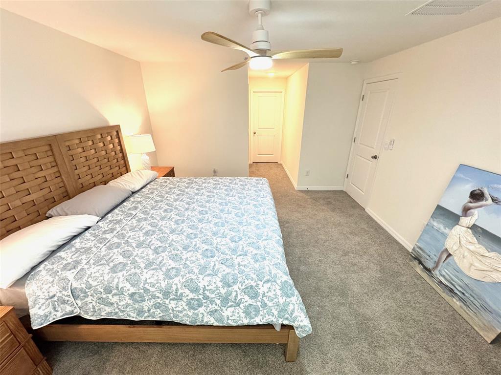 13374 Mylion Way Spring Hill, FL 34610 - Photo 15 of 39 a bedroom with a bed and a dresser
