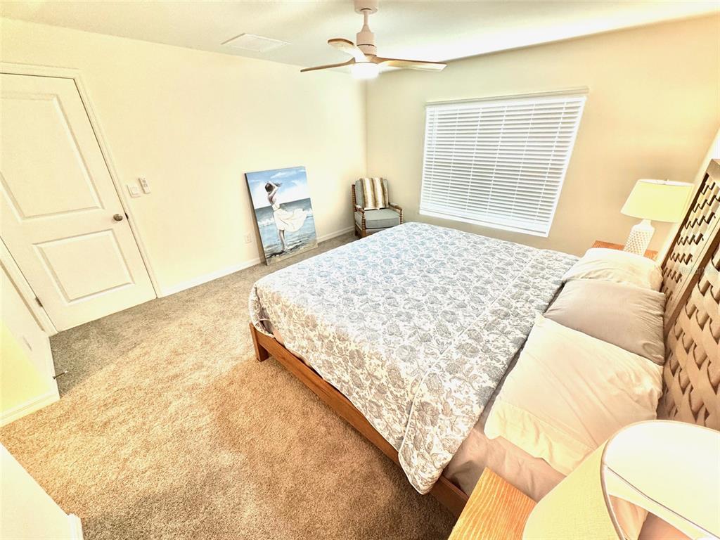 13374 Mylion Way Spring Hill, FL 34610 - Photo 16 of 39 a bedroom with a bed and attached bathroom