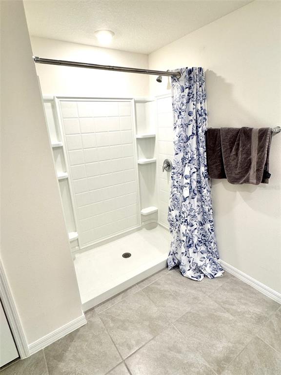 13374 Mylion Way Spring Hill, FL 34610 - Photo 21 of 39 a bathroom with a bathtub and shower