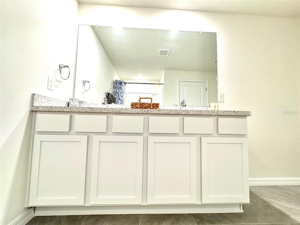 13374 Mylion Way Spring Hill, FL 34610 - Photo 22 of 39 a bathroom with a sink and a mirror