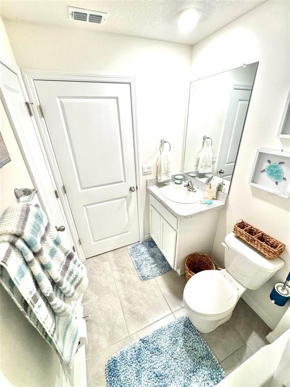 13374 Mylion Way Spring Hill, FL 34610 - Photo 29 of 39 a bathroom with a sink a toilet and a mirror