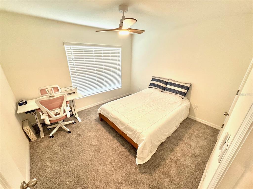 13374 Mylion Way Spring Hill, FL 34610 - Photo 30 of 39 a bedroom with a bed and a window