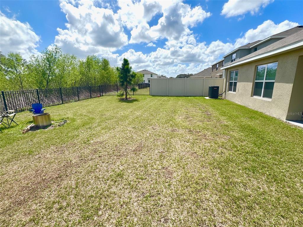 13374 Mylion Way Spring Hill, FL 34610 - Photo 35 of 39 a backyard of a house with table and chairs